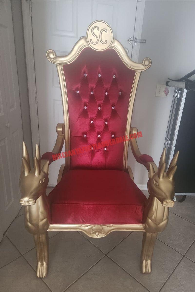 Santa photos: empty gold throne with a red tufted back and reindeer armrests, no Santa