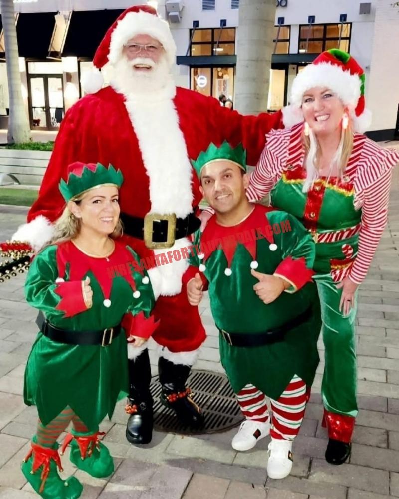 School Santa visit in Broward: Santa outdoors with three elves on pavers at dusk